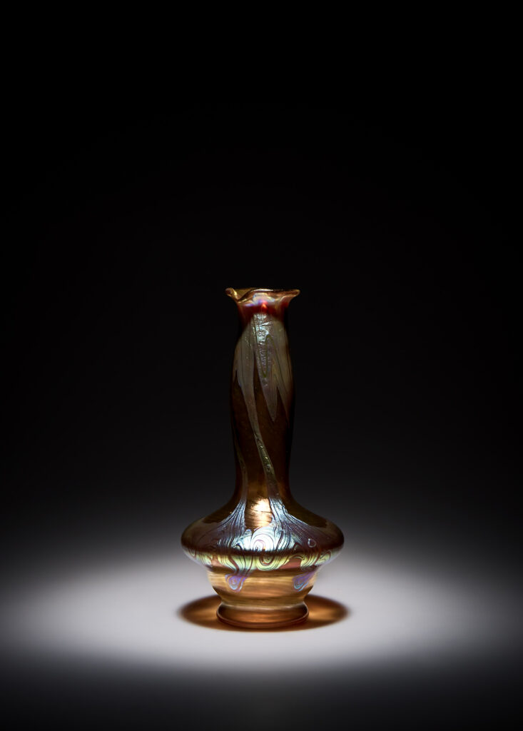 Art Nouveau vase by Johann Loetz Witwe, executed in Phänomen Genre 1/214, blown in orange glass with a richly iridescent surface featuring the characteristic flowing lines and delicate color reflections typical of the Phänomen Genre.