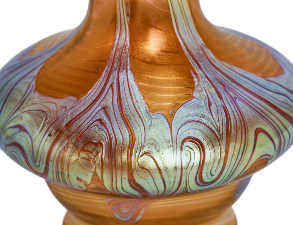 Art Nouveau vase by Johann Loetz Witwe, executed in Phänomen Genre 1/214, blown in orange glass with a richly iridescent surface featuring the characteristic flowing lines and delicate color reflections typical of the Phänomen Genre.